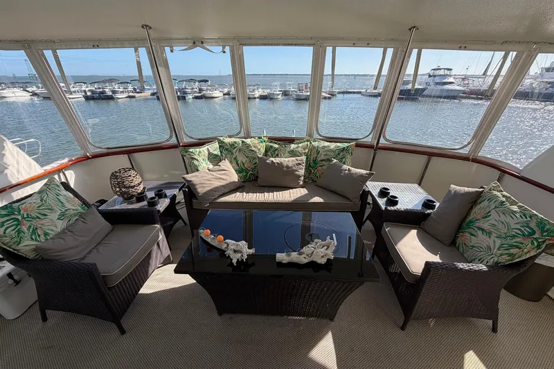 Lady Rae Yacht Photos Pics Luxurious 1987 Hatteras 58 Motor Yacht interior with elegant seating and marina view.