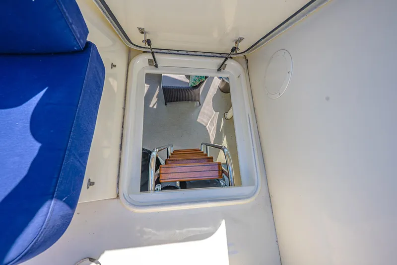 Lady Rae Yacht Photos Pics Hatteras 58 Motor Yacht 1987 interior hatch with wooden steps and blue seating.