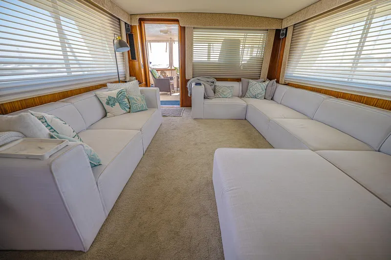 Lady Rae Yacht Photos Pics Luxurious interior of 1987 Hatteras 58 Motor Yacht with spacious seating and elegant decor.