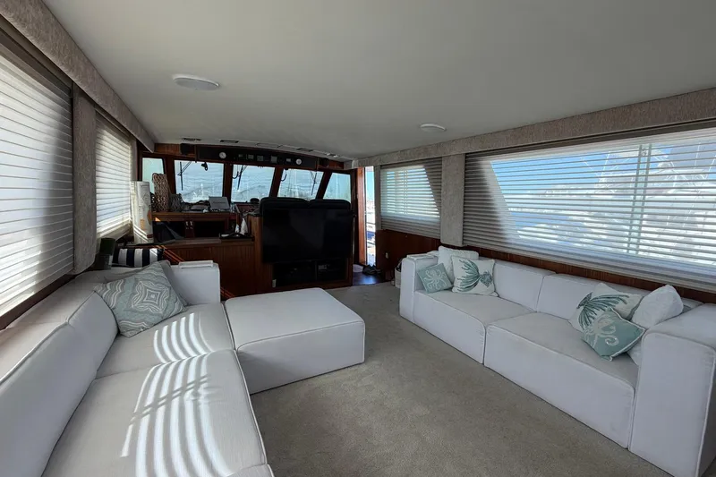Lady Rae Yacht Photos Pics Luxurious interior of 1987 Hatteras 58 Motor Yacht with white sofas and large windows.