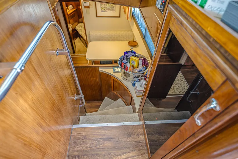 Lady Rae Yacht Photos Pics Interior of 1987 Hatteras 58 Motor Yacht with wooden stairs and dining area.