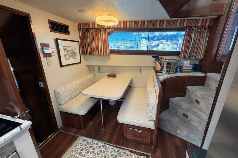 Lady Rae Yacht Photos Pics Interior of 1987 Hatteras 58 Motor Yacht with dining area and staircase.