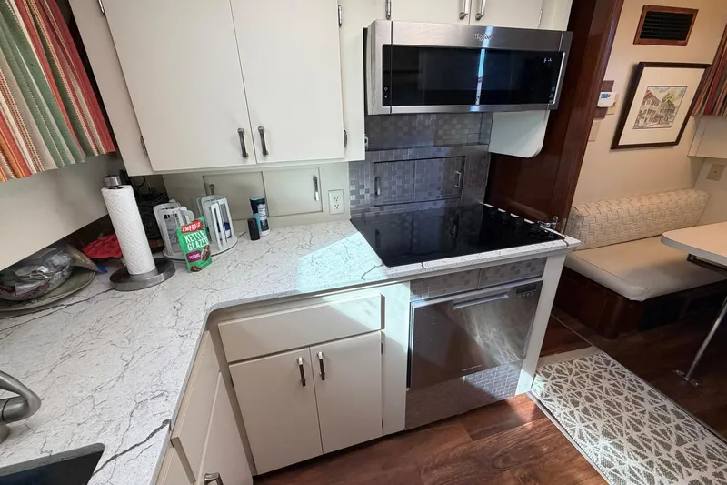 Lady Rae Yacht Photos Pics Modern kitchen in 1987 Hatteras 58 Motor Yacht with sleek appliances and cozy dining area.