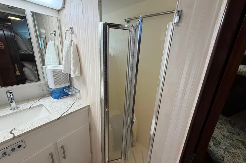 Lady Rae Yacht Photos Pics Bathroom interior of 1987 Hatteras 58 Motor Yacht with shower and vanity.
