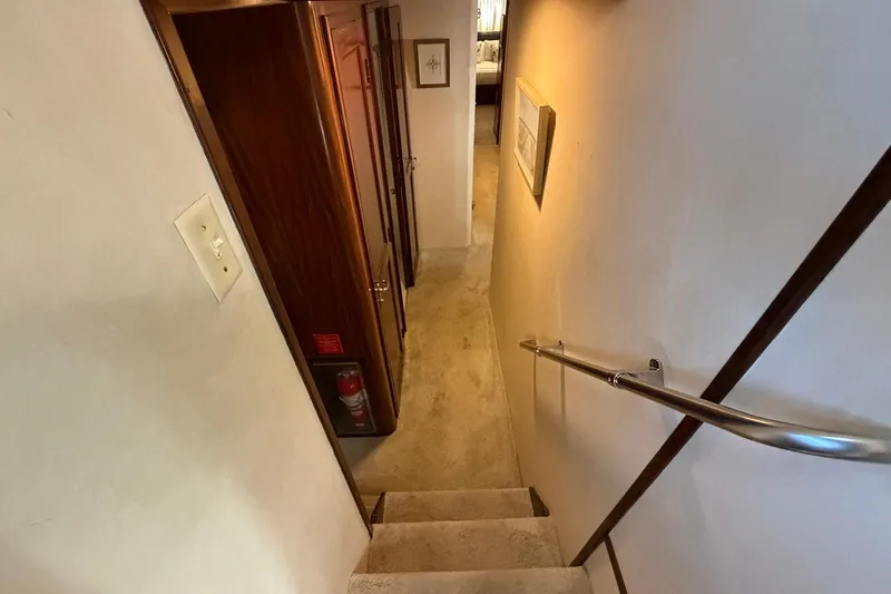 Lady Rae Yacht Photos Pics Stairway inside 1987 Hatteras 58 Motor Yacht with wooden accents and handrail.