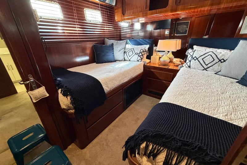Lady Rae Yacht Photos Pics Luxurious cabin interior of 1987 Hatteras 58 Motor Yacht with twin beds and elegant decor.