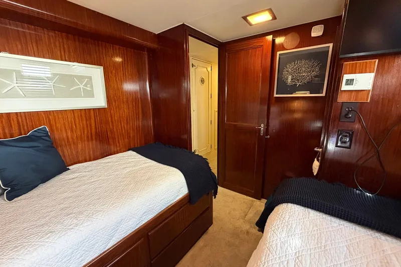 Lady Rae Yacht Photos Pics Interior cabin of 1987 Hatteras 58 Motor Yacht with twin beds and wood paneling.
