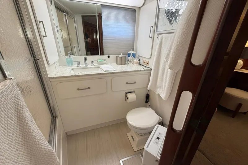 Lady Rae Yacht Photos Pics Bathroom interior of 1987 Hatteras 58 Motor Yacht, featuring sink, toilet, and shower.