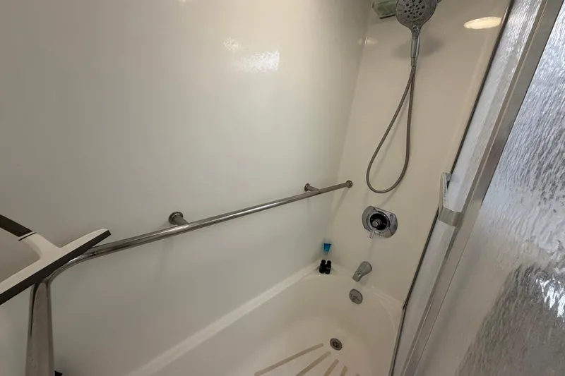 Lady Rae Yacht Photos Pics Shower area in 1987 Hatteras 58 Motor Yacht with handheld showerhead and grab bar.