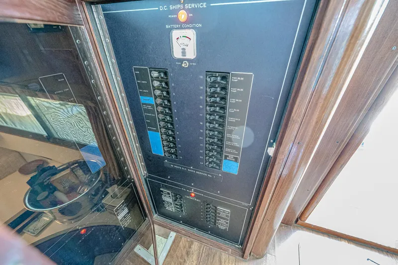 Lady Rae Yacht Photos Pics Electrical panel on 1987 Hatteras 58 Motor Yacht, showcasing circuit breakers and battery condition gauge.