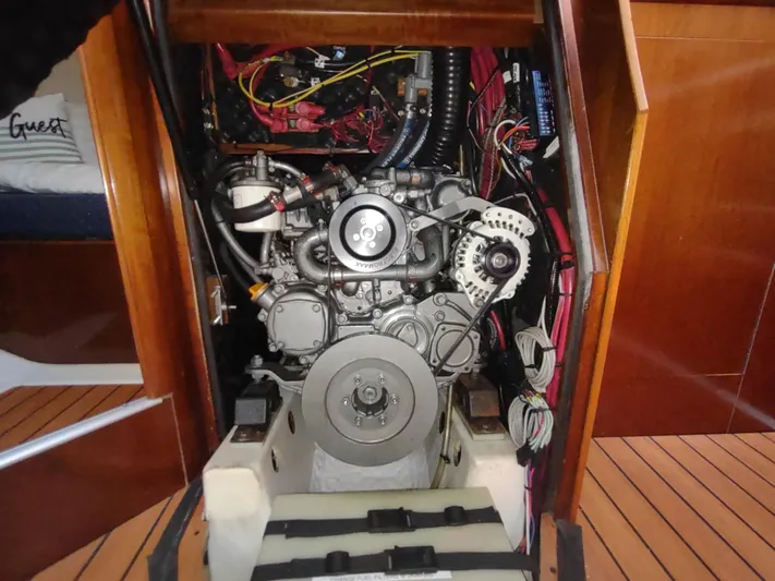 Rarebird Yacht Photos Pics Engine compartment of a 2004 Beneteau 393 sailboat, showcasing detailed mechanical components.