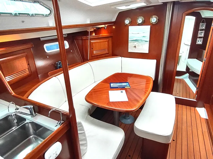 Rarebird Yacht Photos Pics Luxurious interior of a 2004 Beneteau 393 yacht with elegant wood finish.