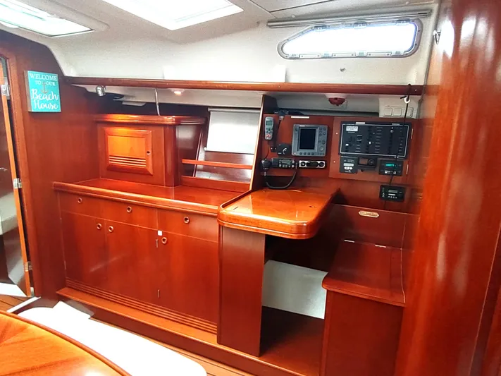Rarebird Yacht Photos Pics Interior of 2004 Beneteau 393 yacht with wooden cabinetry and navigation equipment.