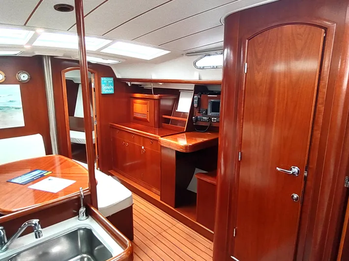 Rarebird Yacht Photos Pics Interior of 2004 Beneteau 393 yacht with polished wood finish and modern amenities.