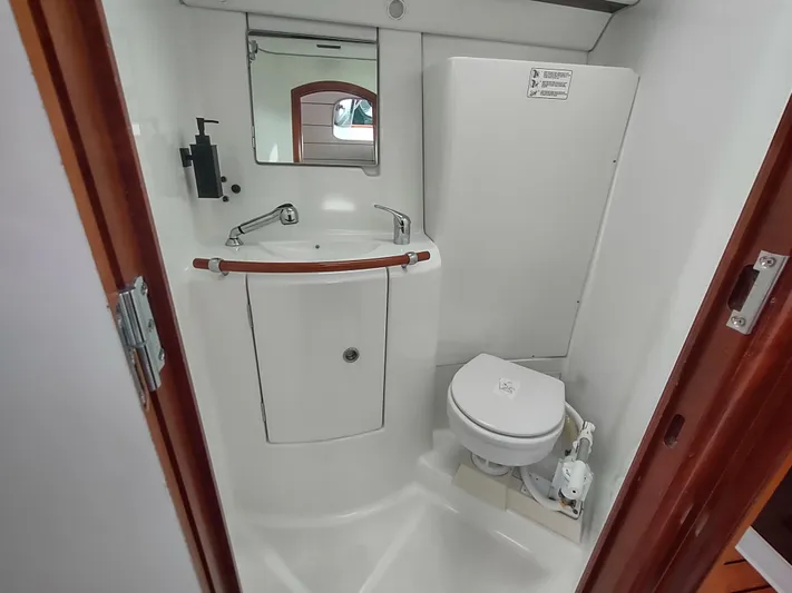 Rarebird Yacht Photos Pics Compact bathroom in a 2004 Beneteau 393 yacht, featuring a sink and toilet.