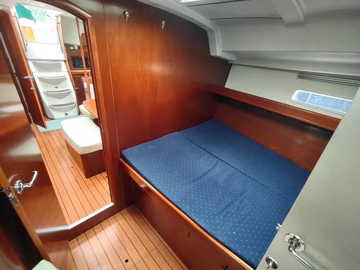 Rarebird Yacht Photos Pics Interior of 2004 Beneteau 393 sailboat, featuring a cozy cabin with wooden finishes.
