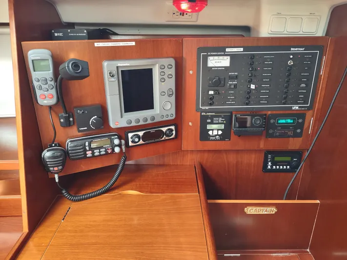 Rarebird Yacht Photos Pics Control panel of a 2004 Beneteau 393 sailboat with navigation and communication equipment.