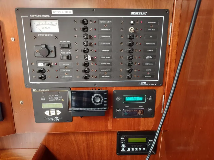 Rarebird Yacht Photos Pics Control panel of a 2004 Beneteau 393 sailboat with various switches and displays.