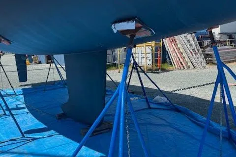 Rarebird Yacht Photos Pics 2004 Beneteau 393 sailboat on stands, blue hull, in a boatyard setting.