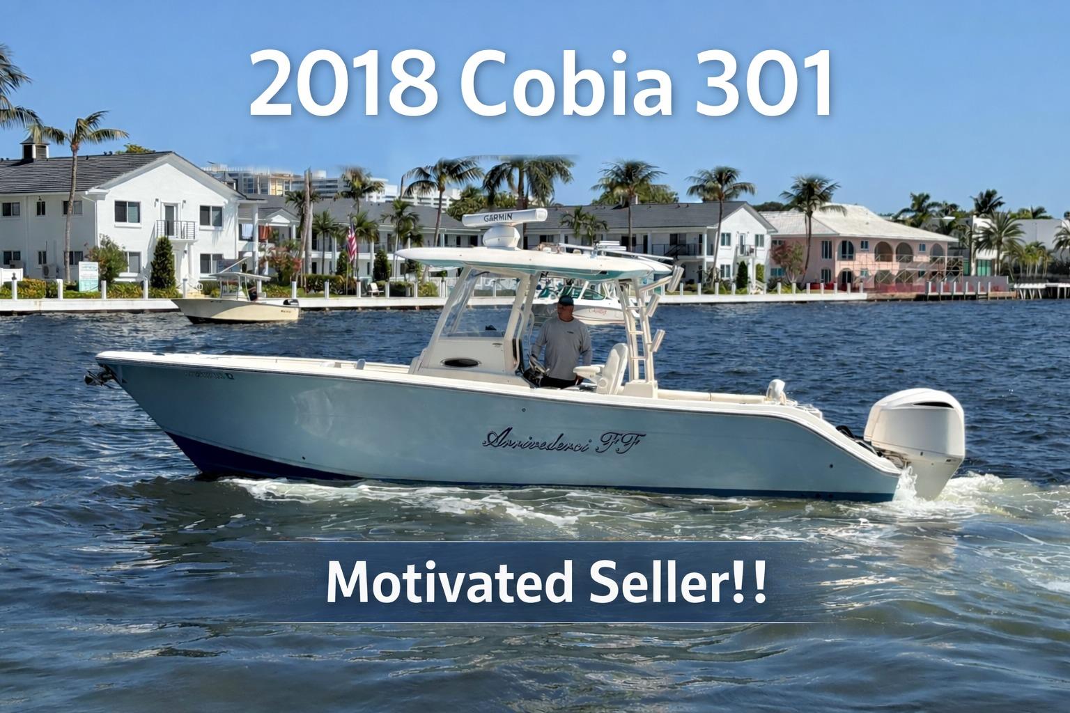 2018 Cobia 301 Center Console boat on water, motivated seller, coastal background.