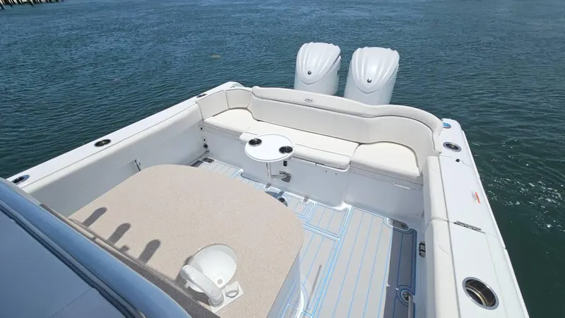  Yacht Photos Pics 2023 Sea Hunt Ultra 305 SE boat interior with seating and twin engines on water.
