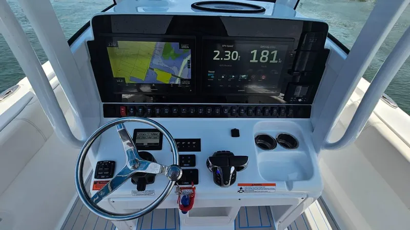  Yacht Photos Pics 2023 Sea Hunt Ultra 305 SE boat dashboard with navigation screens and steering wheel.