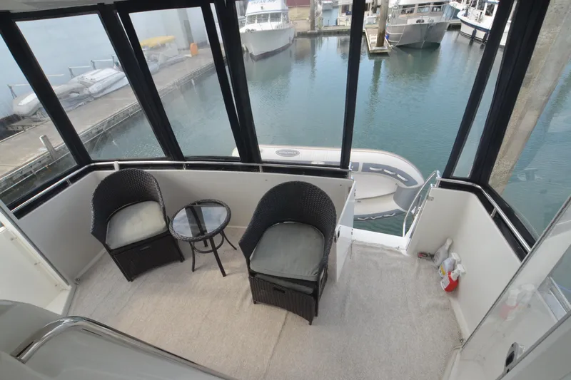 The Loon Yacht Photos Pics 2004 Carver 366 Motoryacht aft deck with wicker chairs and marina view.