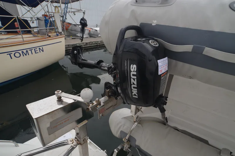 The Loon Yacht Photos Pics Outboard motor on inflatable boat near Carver 366 Motoryacht, 2004 model, docked at marina.