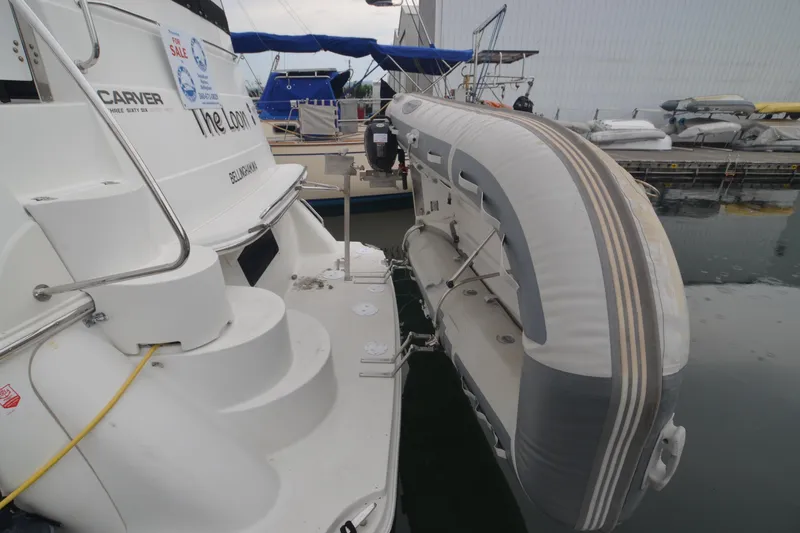 The Loon Yacht Photos Pics 2004 Carver 366 Motoryacht with inflatable dinghy, docked and for sale.