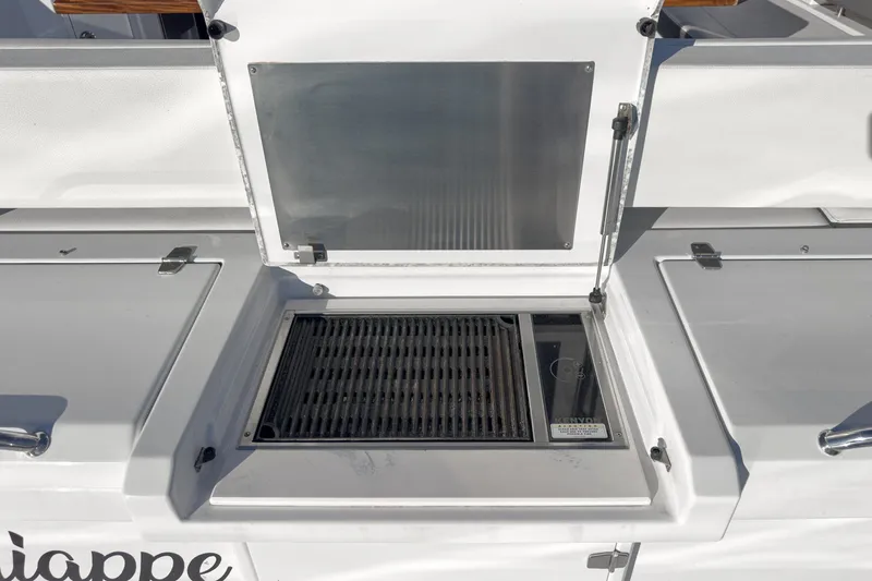 Lagniappe Yacht Photos Pics Outdoor grill on 2023 Cruisers Yachts 42 Cantius, featuring sleek design and functionality.