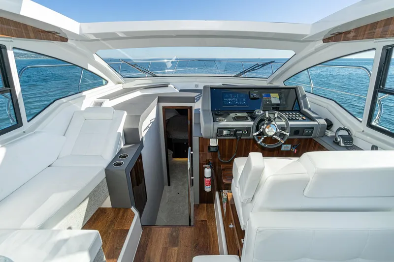 Lagniappe Yacht Photos Pics 2023 Cruisers Yachts 42 Cantius helm with modern controls and luxurious seating.