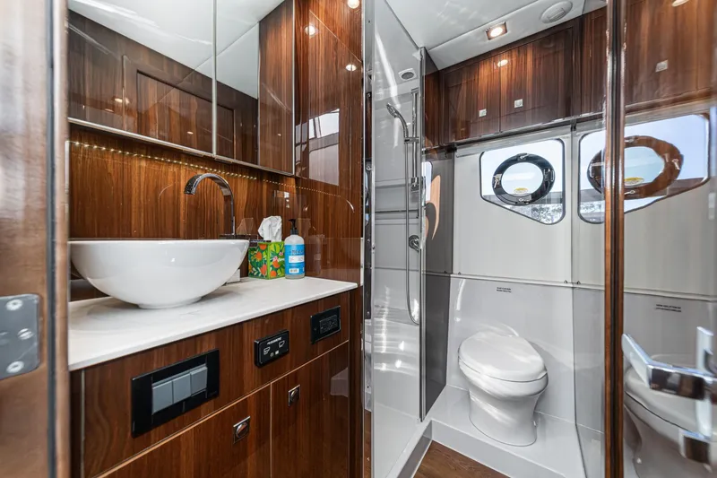 Lagniappe Yacht Photos Pics Luxurious bathroom in 2023 Cruisers Yachts 42 Cantius, featuring modern fixtures and elegant wood finishes.