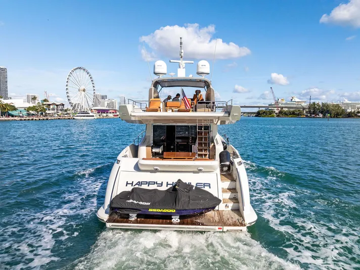  Yacht Photos Pics Azimut 72S yacht cruising in sunny waters, cityscape and Ferris wheel in background.