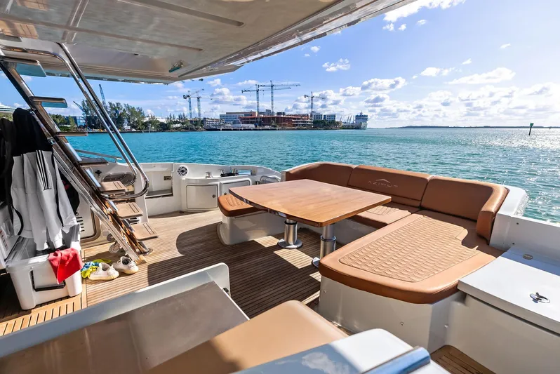  Yacht Photos Pics Luxurious 2014 Azimut 72S yacht deck with seating, overlooking serene waters and distant construction.