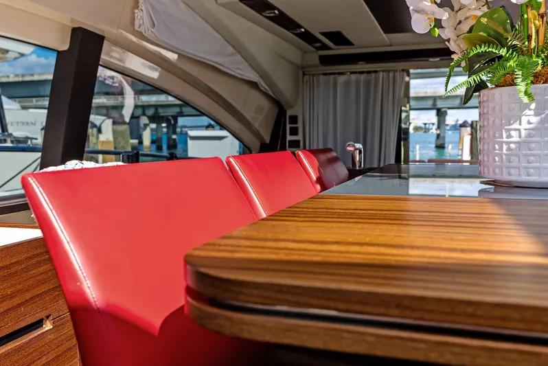  Yacht Photos Pics Luxurious interior of 2014 Azimut 72S yacht with red chairs and wooden table.
