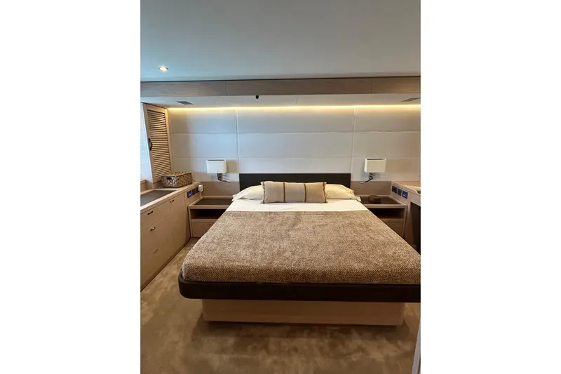 Gran Firin Yacht Photos Pics Luxurious bedroom interior of 2024 Beneteau Grand Trawler 62 yacht, featuring modern design.