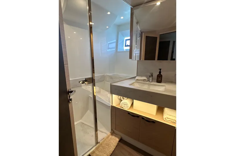 Gran Firin Yacht Photos Pics Luxurious bathroom in 2024 Beneteau Grand Trawler 62, featuring modern fixtures and elegant design.