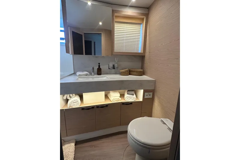 Gran Firin Yacht Photos Pics Luxurious bathroom in 2024 Beneteau Grand Trawler 62, featuring modern fixtures and elegant design.