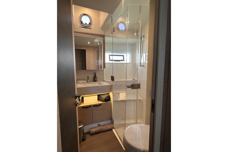 Gran Firin Yacht Photos Pics Luxurious bathroom in 2024 Beneteau Grand Trawler 62 yacht with modern fixtures.