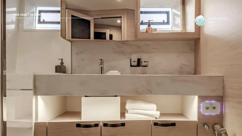 Gran Firin Yacht Photos Pics Modern bathroom interior of 2024 Beneteau Grand Trawler 62 yacht, featuring sleek design and ample storage.