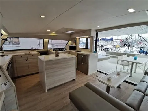  Yacht Photos Pics Luxurious interior of a 2019 Catana 53 catamaran with modern kitchen and seating area.