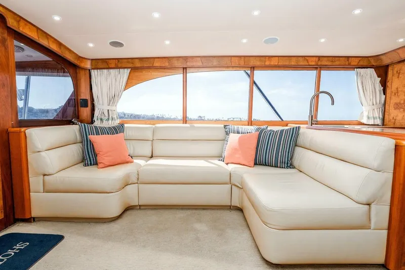 Shotgun Yacht Photos Pics Luxurious interior of 1981 Merritt 55 c yacht with plush seating and decorative pillows.