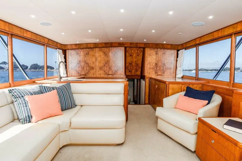 Shotgun Yacht Photos Pics Luxurious 1981 Merritt 55 c yacht interior with plush seating and scenic ocean views.