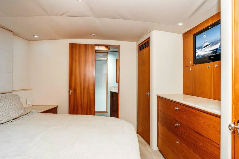 Shotgun Yacht Photos Pics Luxurious cabin interior of 1981 Merritt 55 c yacht with wood finishes and TV.