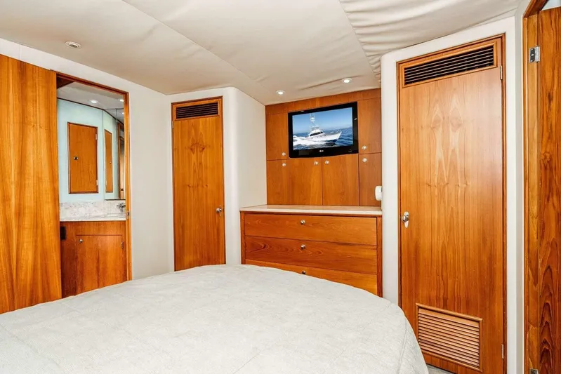 Shotgun Yacht Photos Pics Luxurious 1981 Merritt 55 c yacht bedroom with wood paneling and TV.