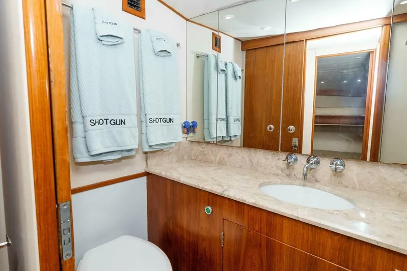 Shotgun Yacht Photos Pics Luxurious bathroom in 1981 Merritt 55 c yacht with marble countertop and wooden cabinetry.