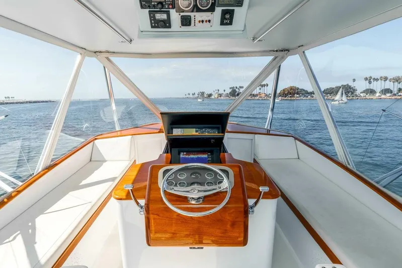 Shotgun Yacht Photos Pics Helm of 1981 Merritt 55 c yacht with ocean view and palm trees.