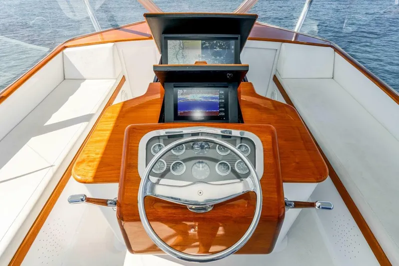 Shotgun Yacht Photos Pics Helm of 1981 Merritt 55 c yacht with wooden dashboard and navigation screens.