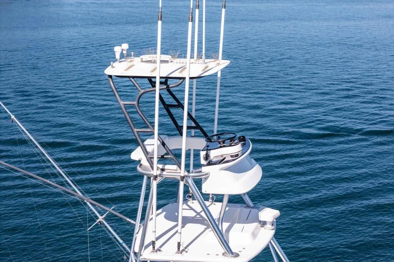 Shotgun Yacht Photos Pics Tower of 1981 Merritt 55 c yacht against a serene ocean backdrop.