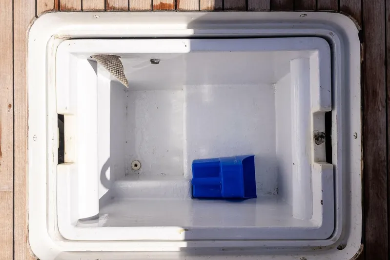 Shotgun Yacht Photos Pics Open storage compartment on 1981 Merritt 55 c boat with blue container inside.